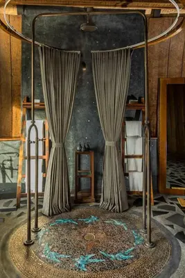 a room with a bed with curtains and a table at Keemala - Birds Nest Pool Villa in Kamala Beach