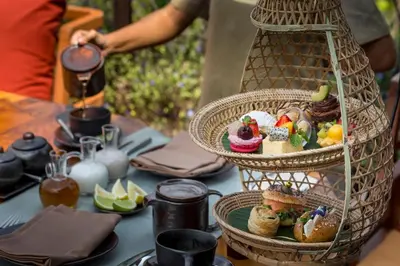 a table with a basket of food on top of it at Keemala - Birds Nest Pool Villa in Kamala Beach