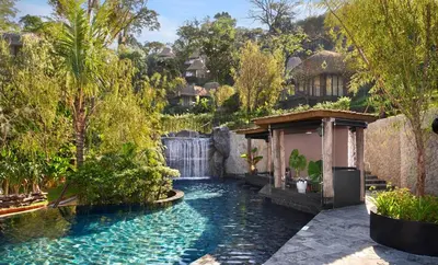 a pool in the middle of a yard with trees at Keemala - Birds Nest Pool Villa in Kamala Beach