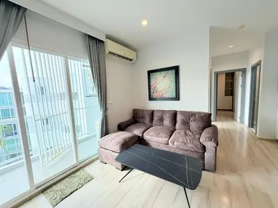 a living room with a couch and large windows at The closest accommodation next too central Mall in Ban Rangeng