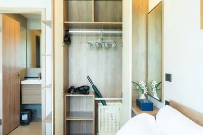 a room with a closet with wooden cabinets at 1BR near Laguna, Space Cherngtalay, Bangtao beach by Pat in Ban Thalat Choeng Thale