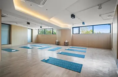 a yoga class with blue mats in a room at Sunshine Layan Beach Resort 2 bedroom #84192 in Layan Beach