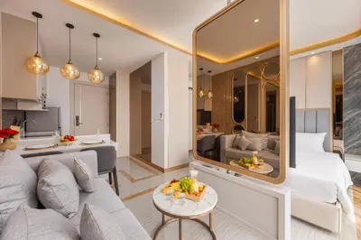 a living room with a white couch and a large mirror at Suite Ostia with Gym Pool Access-Bellevue Lagoon in Laguna Phuket