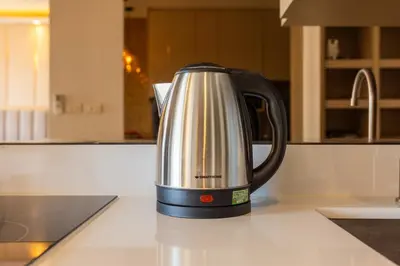 a tea kettle sitting on a counter in a kitchen at Suite Imola Gym Pool Close to Beach – Bellevue in Laguna Phuket