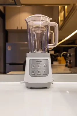 a blender sitting on a counter in a kitchen at Suite Avila 2BR Gym Pool Close to Beach in Laguna Phuket