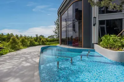 a swimming pool in the middle of a house at Suite Avila 2BR Gym Pool Close to Beach in Laguna Phuket