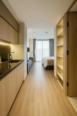 a kitchen and a bedroom with a bed in a room at Layan Green Park Studio by Search Estate in Phuket