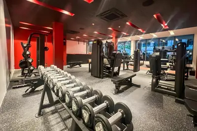 a gym with several rows of tread machines at Layan Green Park Studio by Search Estate in Phuket
