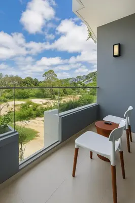 a room with a balcony with a view of the desert at Layan Green Park Studio by Search Estate in Phuket