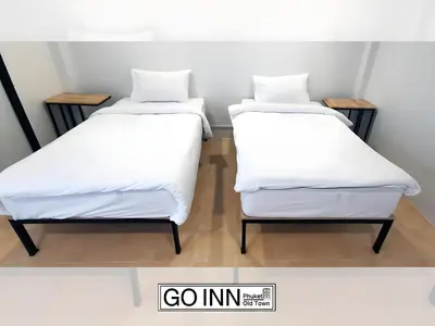 two beds sitting next to each other in a room at XX GO INN Seng Ho Phuket - โอลทาวน์ Oldtown in Phuket Town