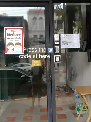 a door with a sign that says stress the code at here at XX GO INN Seng Ho Phuket - โอลทาวน์ Oldtown in Phuket Town