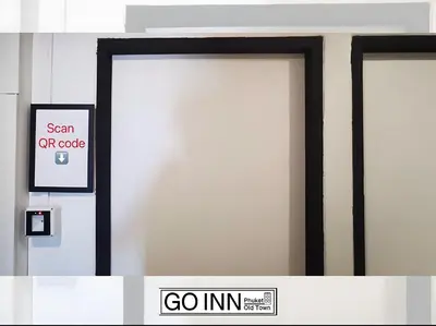 two doors in a building with a go in sign at XX GO INN Seng Ho Phuket - โอลทาวน์ Oldtown in Phuket Town