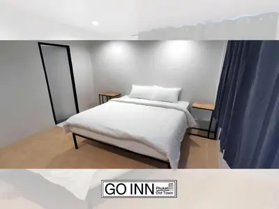 a bedroom with a bed with white sheets at XX GO INN Phuket City - โกอินน์ ภูเก็ต โอลทาวน์ Old Town in Phuket Town