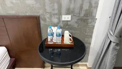 a table with three water bottles on top of it at The Sense in Patong Beach