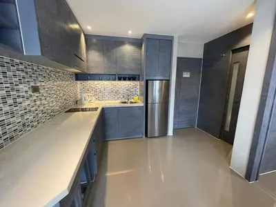 a kitchen with gray cabinets and a stainless steel refrigerator at Popular Kamala City Gate 1 bdr 3 Pools in Kamala Beach