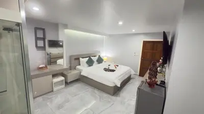 a bedroom with a bed and a large mirror at Family House Patong - Homestay in Patong Beach