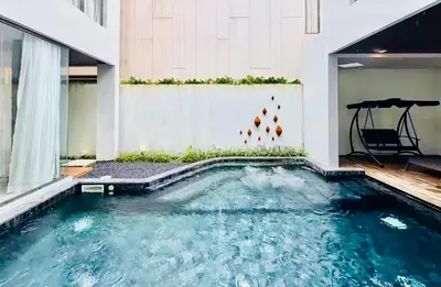 a swimming pool in the middle of a building at Private Villa at Mida Grande Resort in Surin Beach