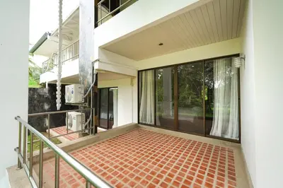 an empty balcony of a house with glass doors at Blue Canyon Golf and Country Club Villa 97 in Ban Muang Mai (1)