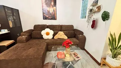 a living room with a brown couch and a glass table at 209 Patong loft condominium in Patong Beach