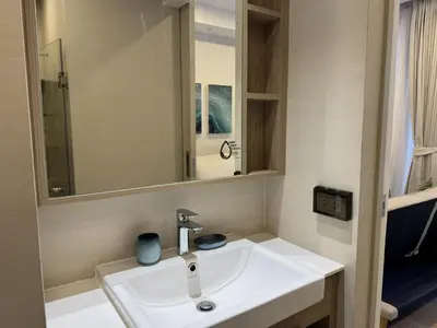 a bathroom with a white sink and a mirror at Private apartment at Skypark in Laguna by Lofty in Laguna Phuket