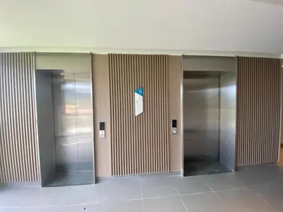 a hallway with three elevators in a building at Private apartment at Skypark in Laguna by Lofty in Laguna Phuket