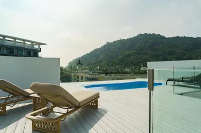 a deck with two lounge chairs and a swimming pool at 2BR Penthouse with Private Pool Rooftop Absolute Twin Sands 5404 in Patong Beach