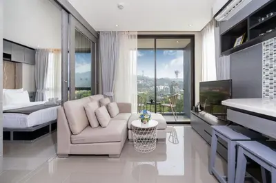 a living room with a couch and a bed at Modern Residence Tropics CTG-L709 with Medical and Wellness Center in Kamala Beach