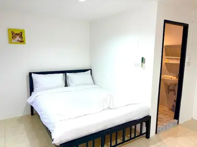 a bedroom with a bed with white sheets at Patong Canal Villa 304 in Patong Beach