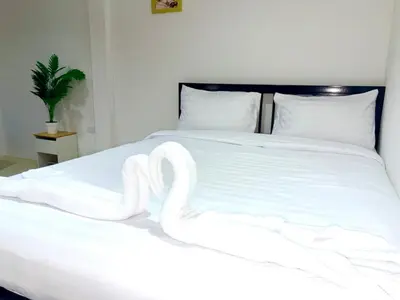 a white bed with swans made out of towels at Patong Canal Villa 304 in Patong Beach