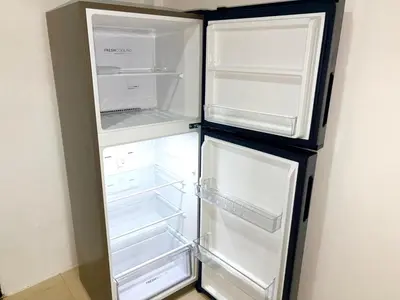 an empty refrigerator with its doors open in a room at Patong Canal Villa 304 in Patong Beach