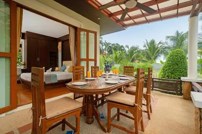 a dining room with a table and chairs and a bedroom at Villa with Huge Private Pool and Tropical Garden Just 10 Minutes Walk to Kamala Beach in Kamala Beach