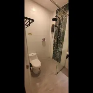 a bathroom with a toilet and a shower at New Five Star Home- Patong Beach in Patong Beach