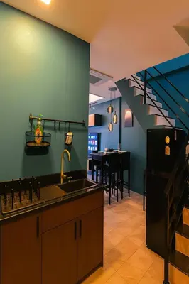 a kitchen with a sink and a kitchen with a staircase at New Five Star Home- Patong Beach in Patong Beach