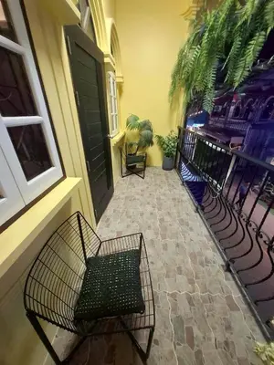 a porch with chairs and a black door at New Five Star Home- Patong Beach in Patong Beach
