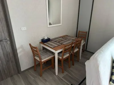 a dining room table with chairs and a mirror at Апартаменты Пхукет in Phuket Town