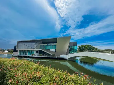 a building with a bridge over a river at Great 1Bdr Royal Lee Nayang beach in Ban Bo Han