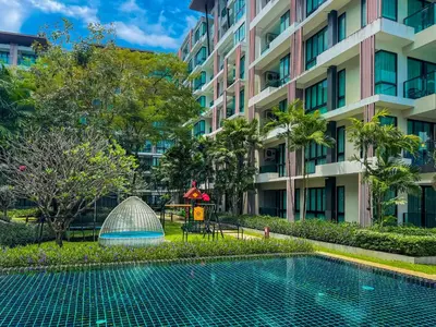 a swimming pool in front of a building at Great 1Bdr Royal Lee Nayang beach in Ban Bo Han