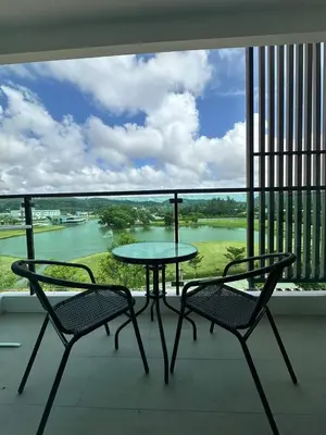 a table and chairs on a balcony with a view of a river at Great 1Bdr Royal Lee Nayang beach in Ban Bo Han