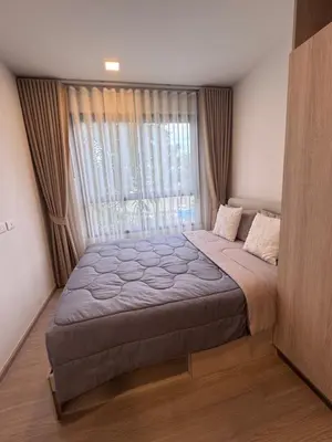 a bedroom with a large bed with a large window at DCondo Kathu ใกล้หาดป่าตอง in Kathu
