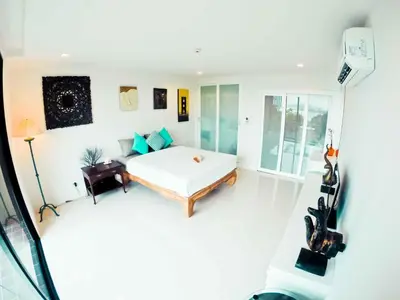 a white bedroom with a bed and a couch at Seaview At Cape Panwa in Panwa Beach