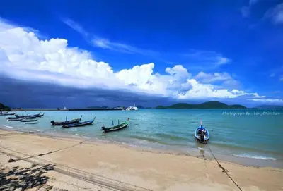 a group of boats in the water on a beach at Seaview At Cape Panwa in Panwa Beach