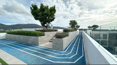 a swimming pool on the roof of a building at Magnificent apartments in Laguna in Laguna Phuket