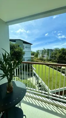 a balcony with a table and a view of a field at Title V - 1 br Bamboo Rawai Apartment in Karon Beach