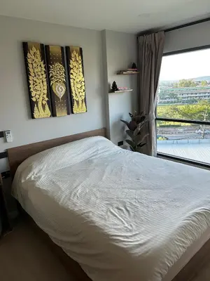 a bedroom with a white bed and a window at Flat near the beach with gym, pool, sauna and workspace in Ban Thalat Choeng Thale