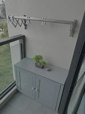a table with a plant on it next to a window at Flat near the beach with gym, pool, sauna and workspace in Ban Thalat Choeng Thale