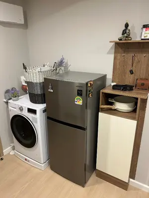 a kitchen with a washing machine and a washer at Flat near the beach with gym, pool, sauna and workspace in Ban Thalat Choeng Thale