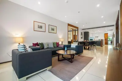 a living room with couches and a table at Stylish 2BR Resort Condo with Seaview Surin in Phuket Town