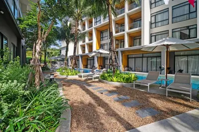 a resort with a pool and chairs and umbrellas at Wyndham 2229 Naiton Beach Studio Forrest View in Phuket Town