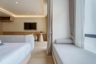 a hotel room with a bed and a tv at Wyndham 2229 Naiton Beach Studio Forrest View in Phuket Town