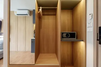 a room with a closet with a tv in it at Beachfront 1524 Wyndham Gardens Condo Naithon in Phuket Town